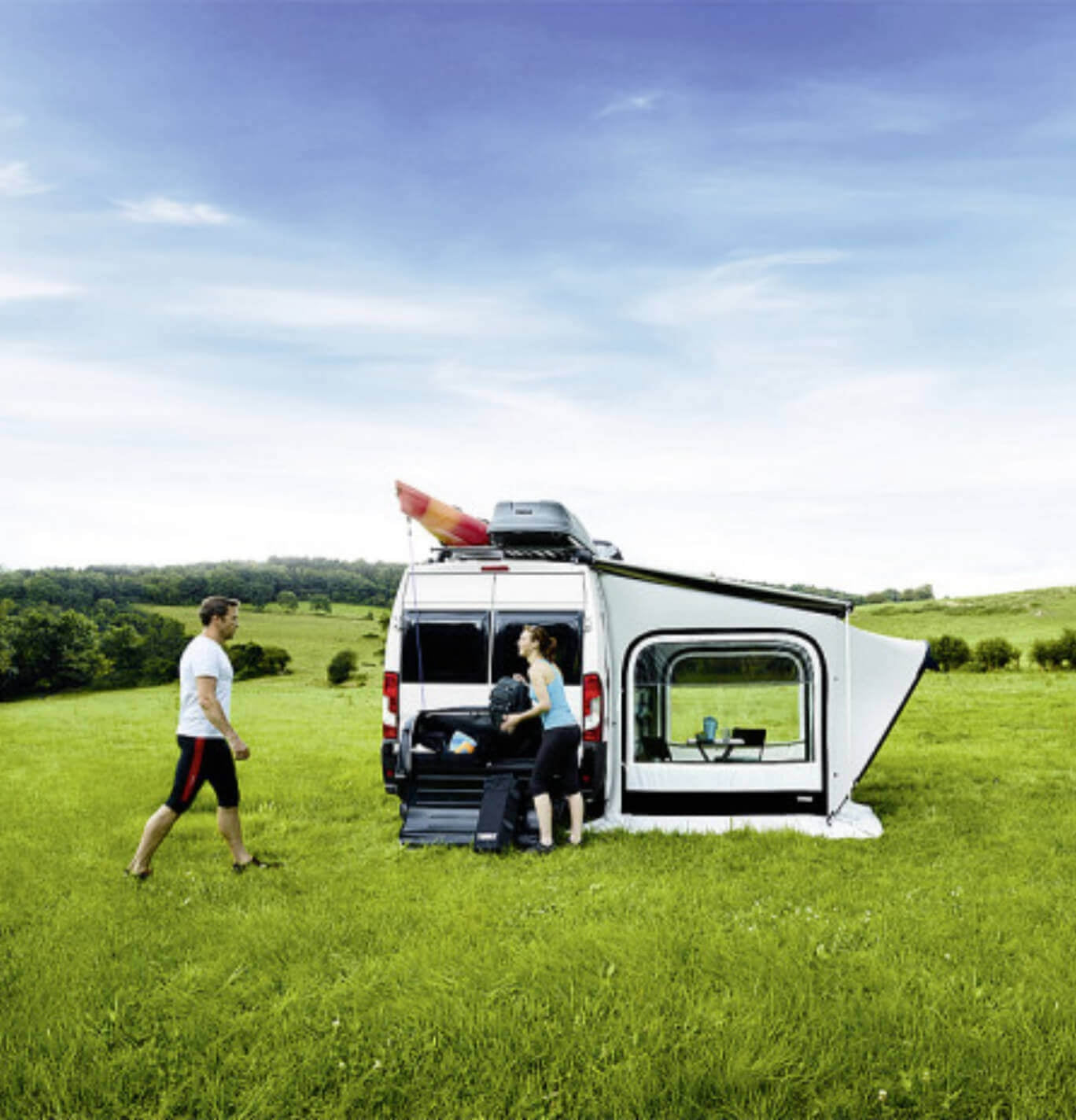 People beside the fiat ducato & 6300 awning pitched with a privacy room
