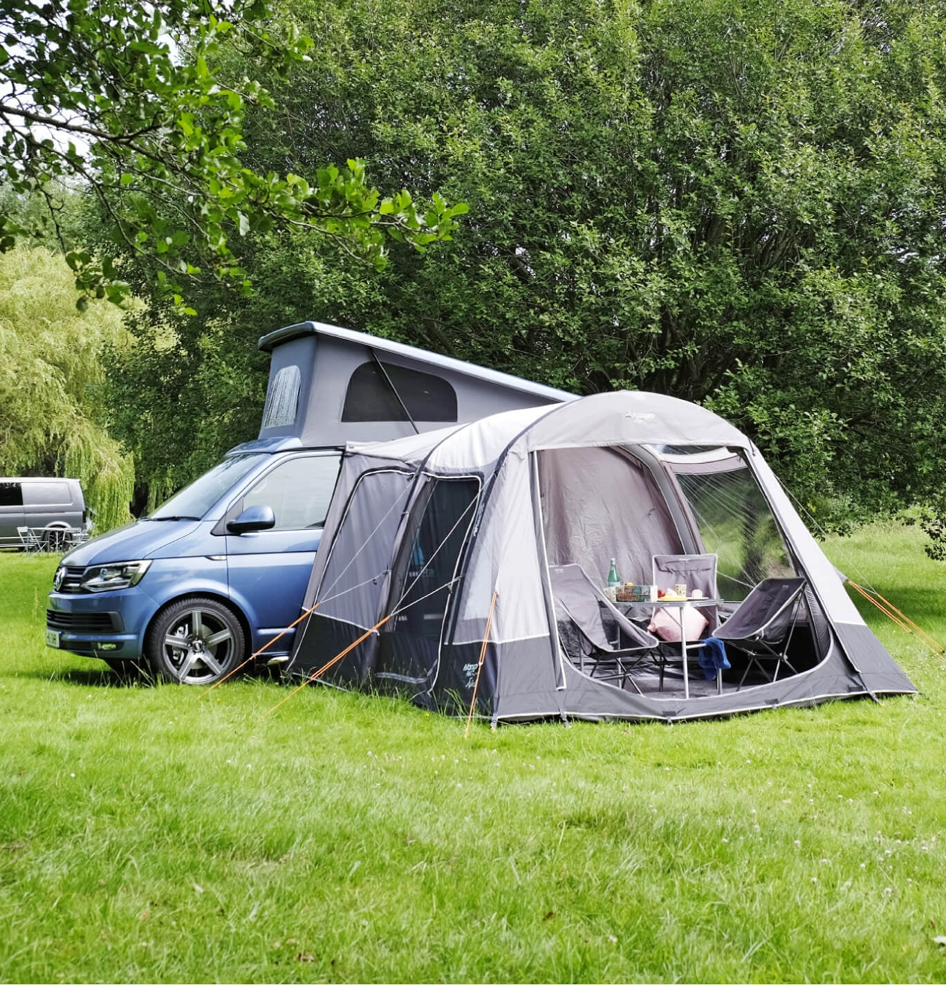 Vango Kela pitched to a VW with camping furniture set up