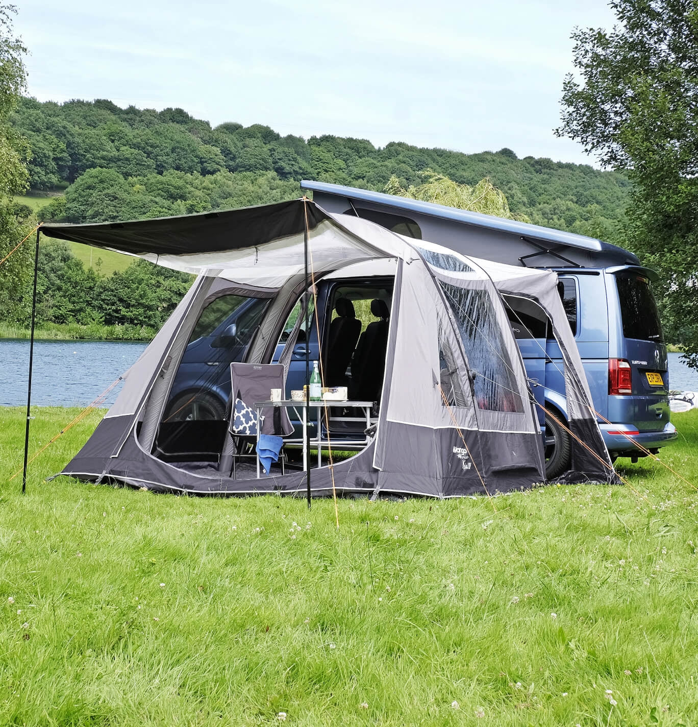 The Vango Kela with sun canopy and chairs pitched to a VW