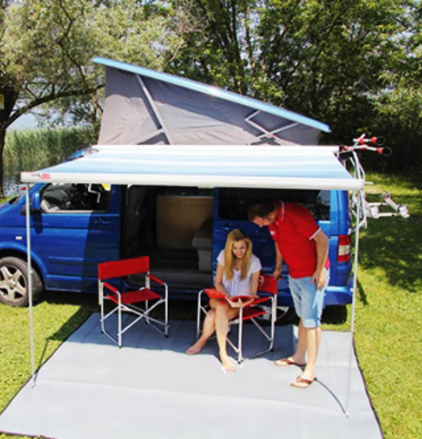 Fiamma F45s attached to the VW with people reading and relaxing