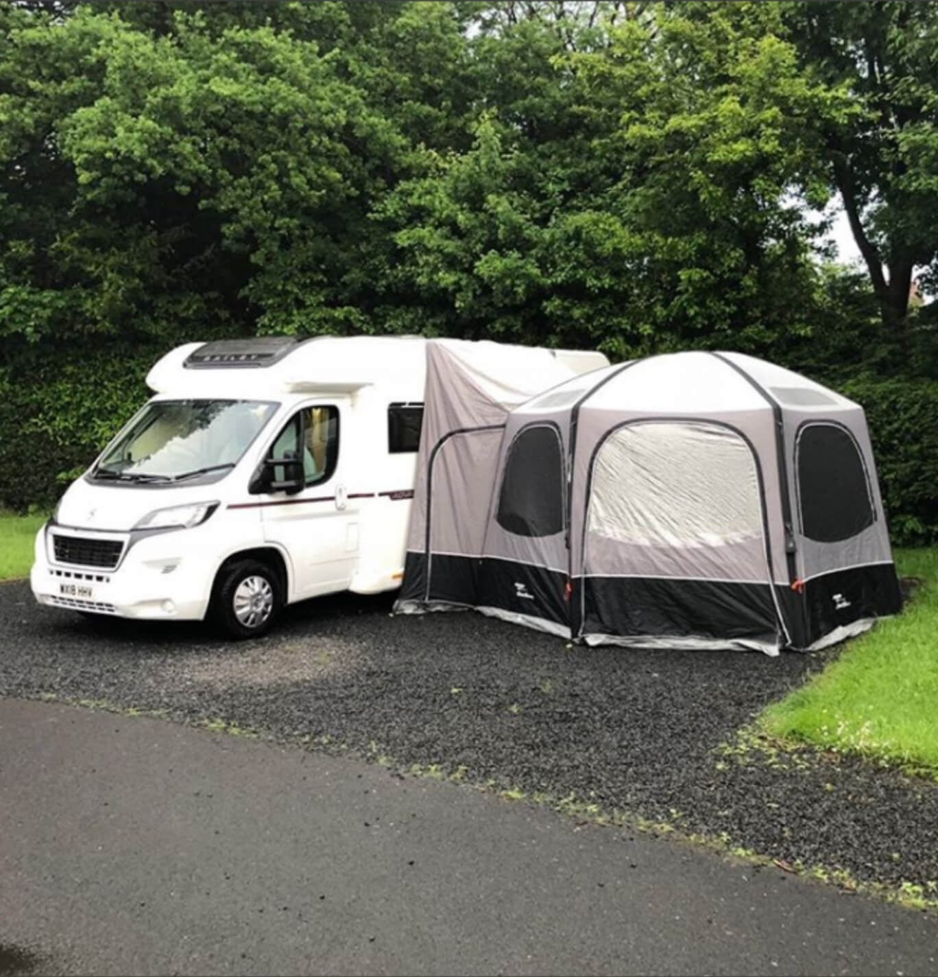 The tall hexaway drive away awning set up to a large motorhome