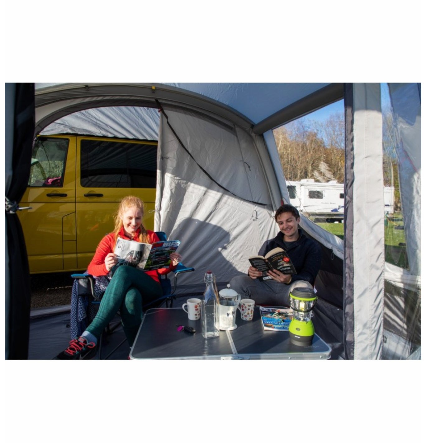 Reading and relaxing in the Vango Tolga AirWay Drive Away Awning